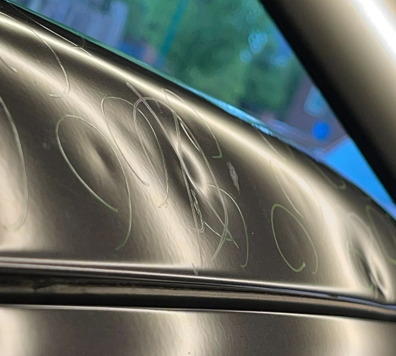 Close-up of hail dents on a painted metal body panel